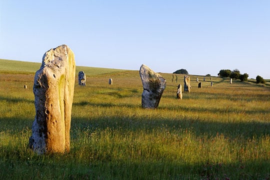 The large sarsen stones of the Avenue march northwards towards the B4003 road approcahing Avebury The large sarsen stones of the Avenue march northwards towards the B4003 road approcahing Avebury